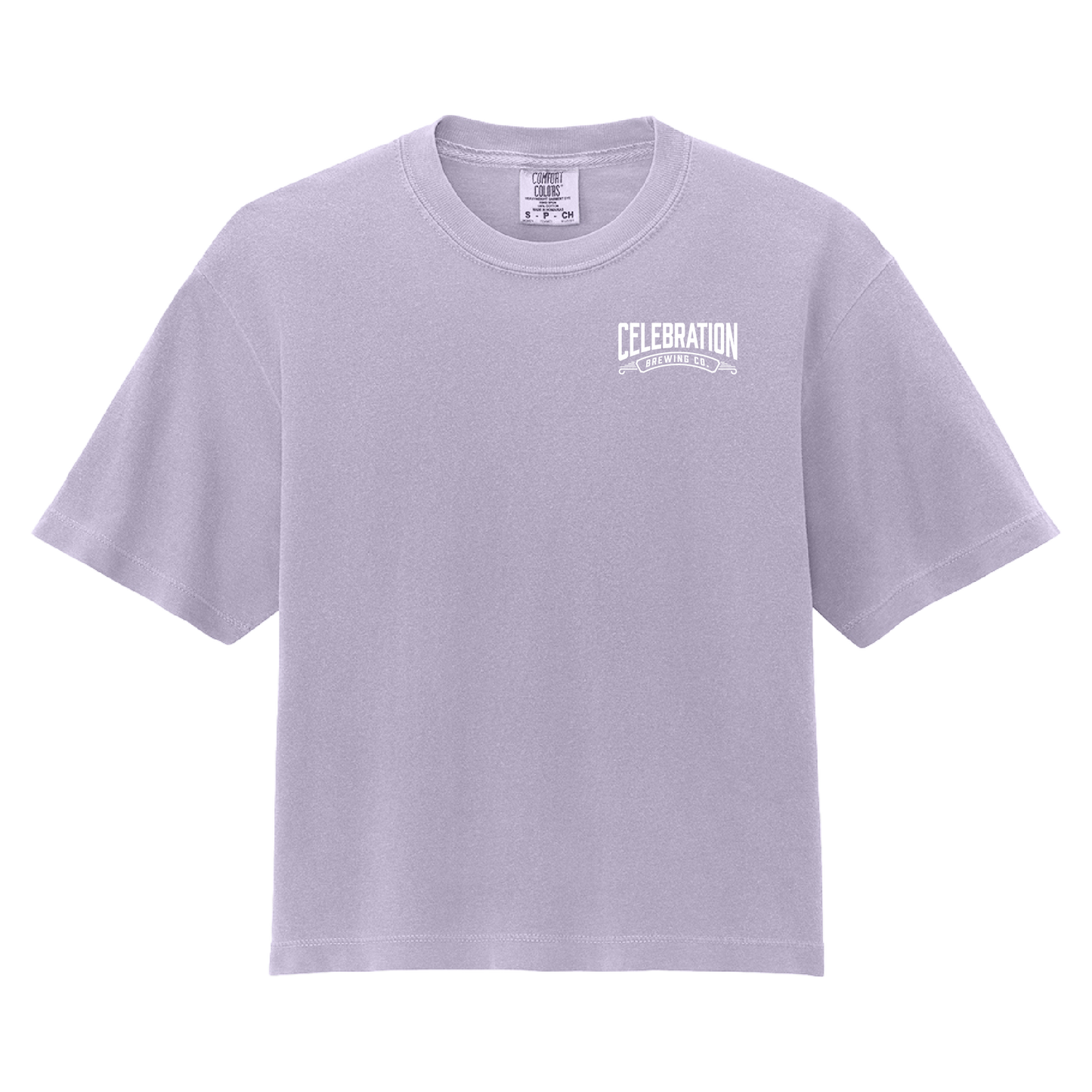 A light lavender crewneck t-shirt with a white graphic print on the left chest reading 'CELEBRATION' and 'ONE CELEBRATING EVERY DAY'. The shirt is displayed flat against a solid white background.