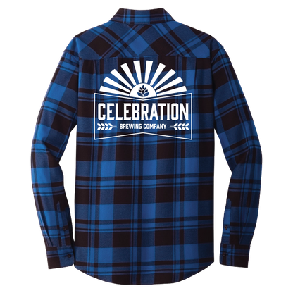 A long-sleeve plaid flannel shirt shown from the back, featuring a blue and black tartan pattern with a large white graphic print on the center that reads 'CELEBRATION BREWING COMPANY' with a sunburst and beer bottle icon.