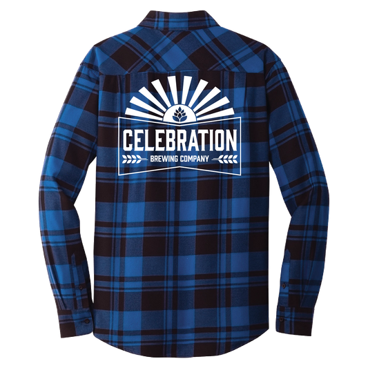 A long-sleeve plaid flannel shirt shown from the back, featuring a blue and black tartan pattern with a large white graphic print on the center that reads 'CELEBRATION BREWING COMPANY' with a sunburst and beer bottle icon.