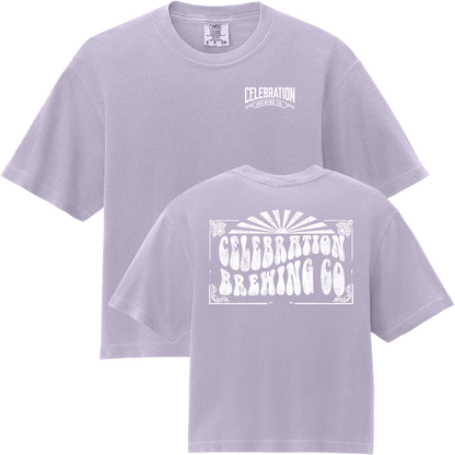 A light lavender crewneck t-shirt shown from both the front and back. The front features a small white 'Celebration Brewing Co' logo on the left chest, and the back features a large, distressed white graphic with the same brand name.
