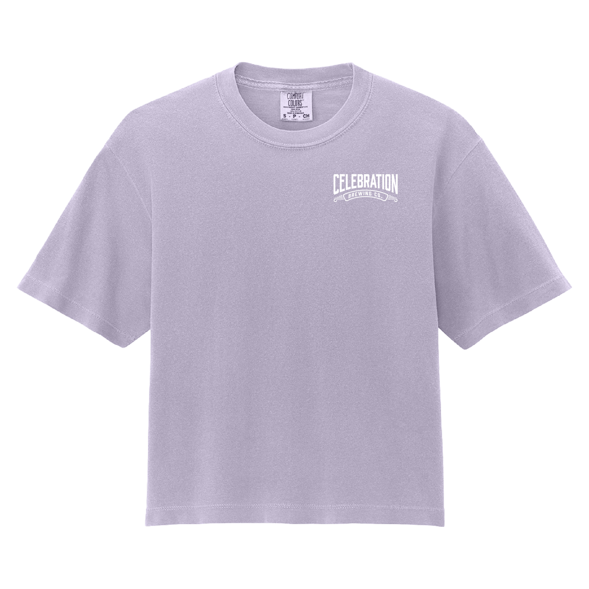 A light lavender crewneck t-shirt with a white graphic print on the left chest reading 'CELEBRATION' and 'ONE CELEBRATING EVERY DAY'. The shirt is displayed flat against a solid white background.